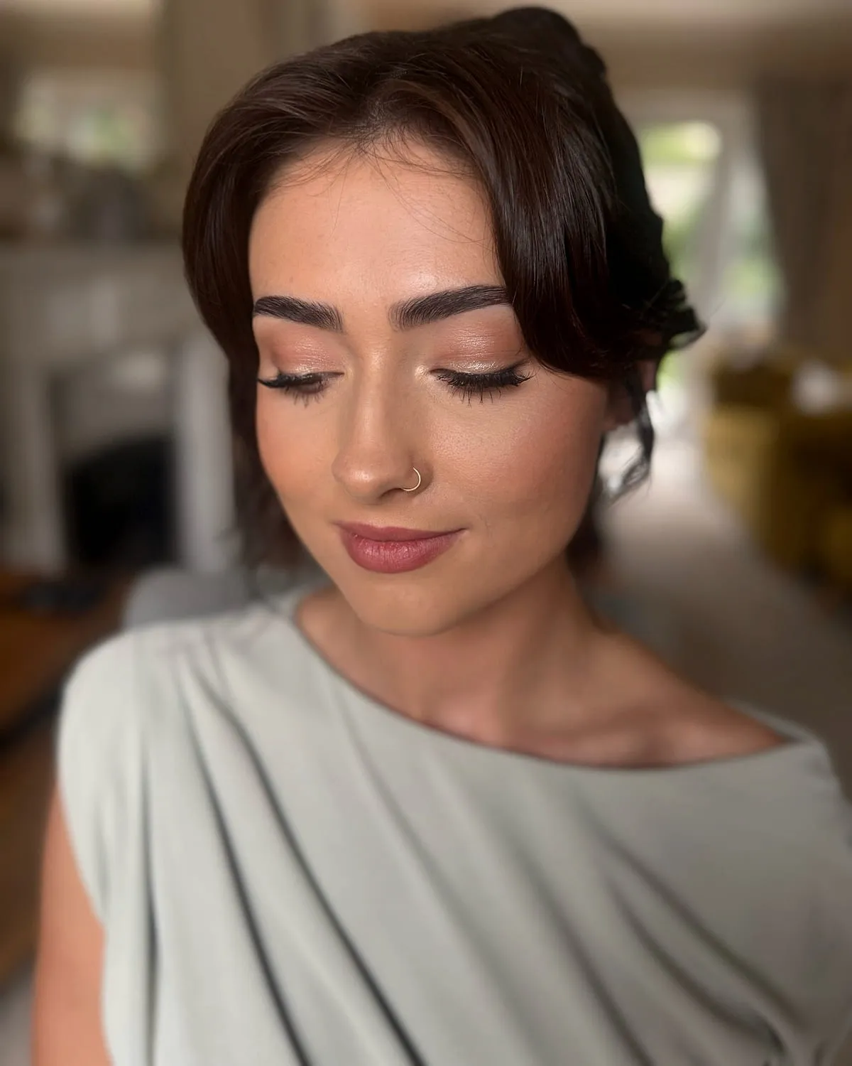 Bridesmaid makeup in soft neutral tones, eyes lowered
