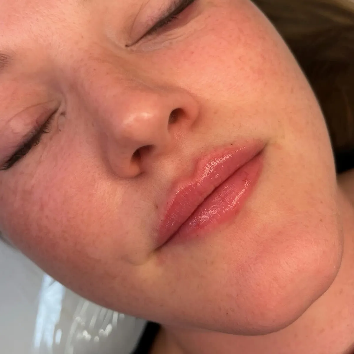 Close detail of the lips with a glossy finish